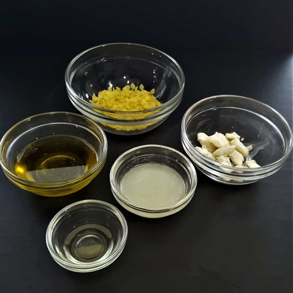 Natural ingredients for DIY dog paw balm. Shea butter, beeswax, olive oil and coconut oil.